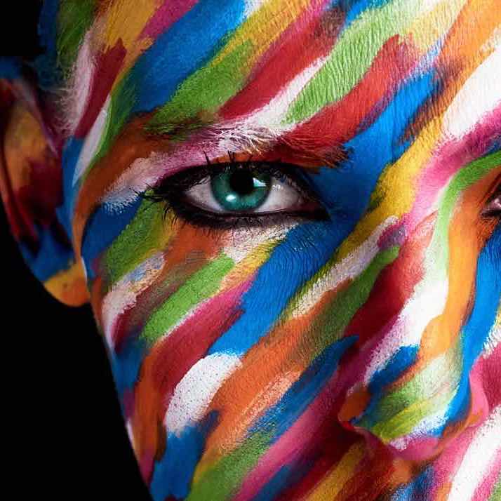 Cropped portrait of a young woman posing with paint on her face